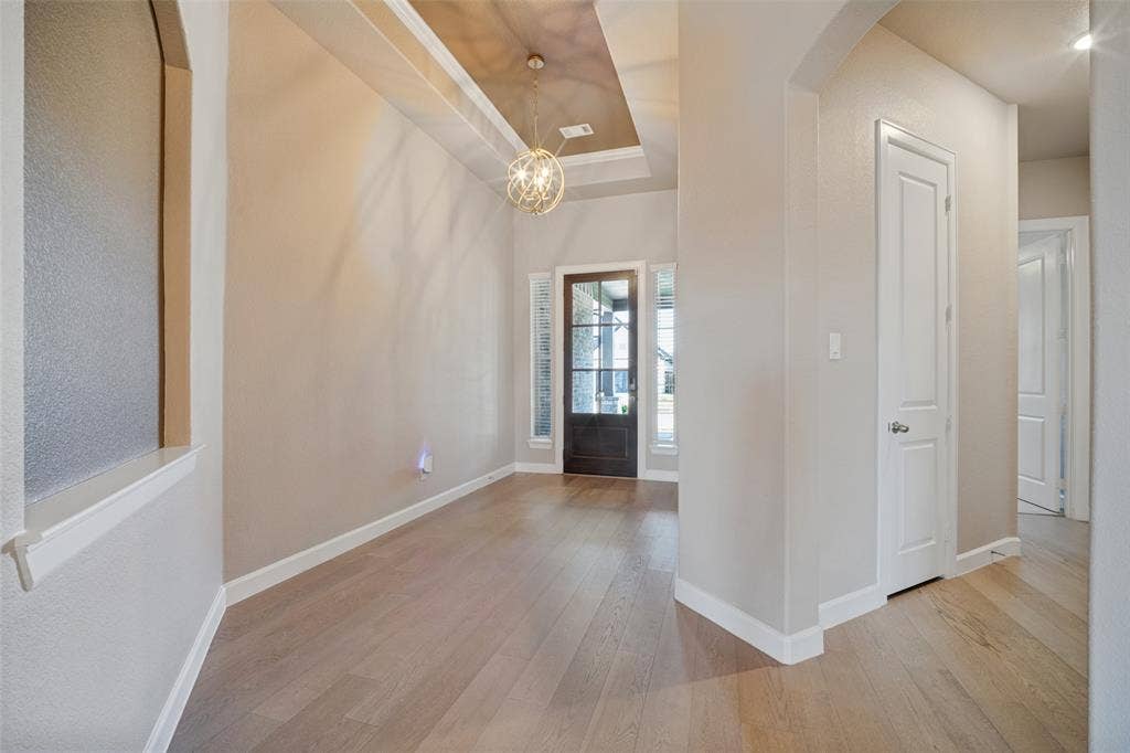 Enter this home to tall ceilings, neutral clean paint, and gorgeous light wood-look floors