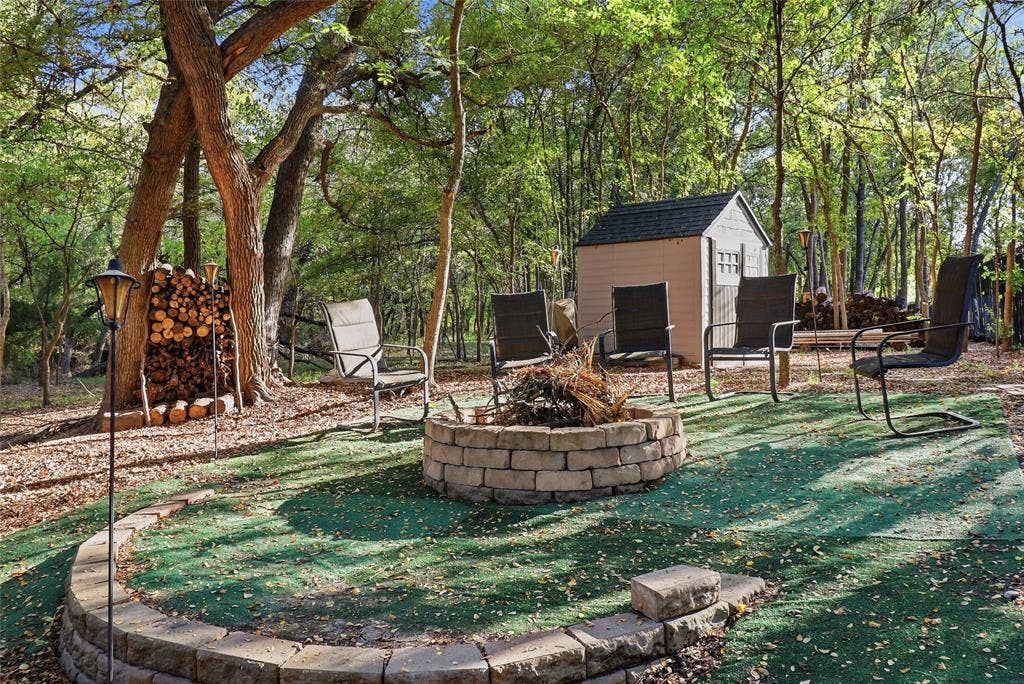 1614 Jeffrey Drive, Wylie, TX 75098 Fire pit, lots of area for seating, storage shed and firewood