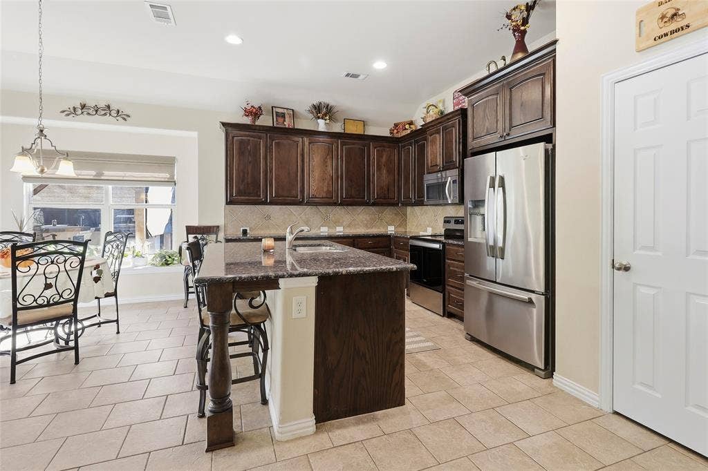 1614 Jeffrey Drive, Wylie, TX 75098 Center kitchen island bar is perfect for extra seating and entertaining.