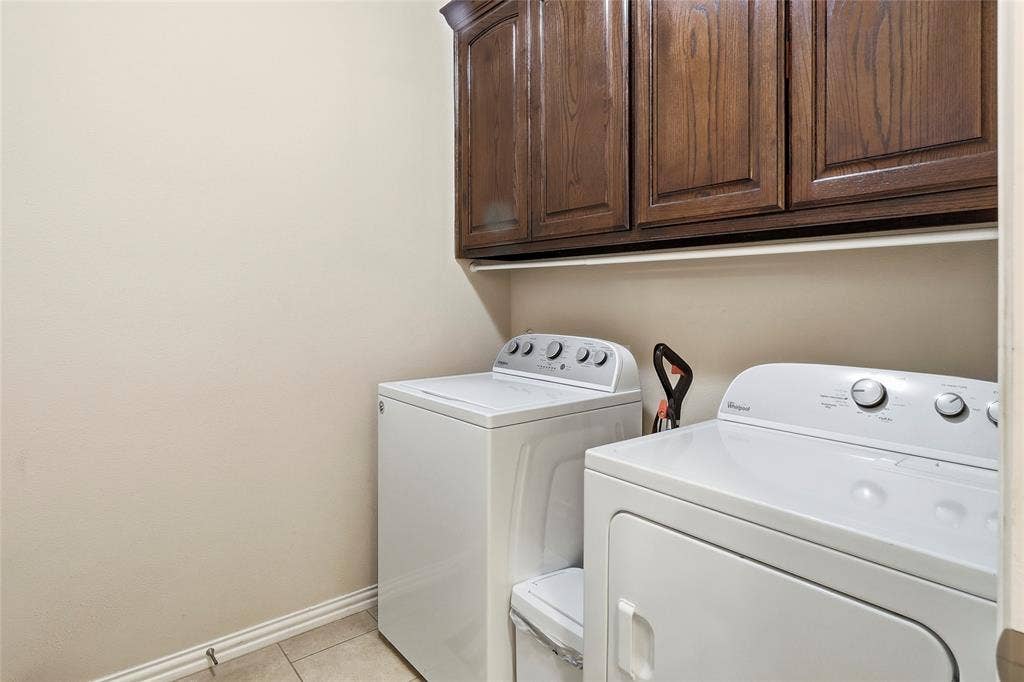 1614 Jeffrey Drive, Wylie, TX 75098 Spacious utility room with built-in cabinetry.