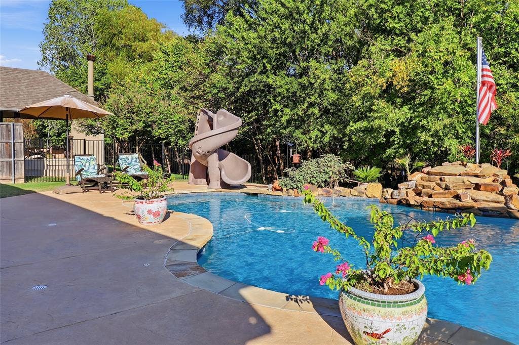 1614 Jeffrey Drive, Wylie, TX 75098 View from covered patio to slide and waterfall.