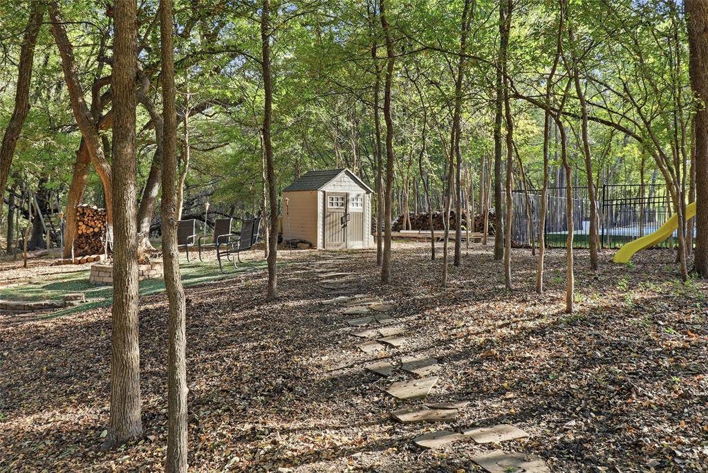 1614 Jeffrey Drive, Wylie, TX 75098 Stone walkway to firepit and storage shed.