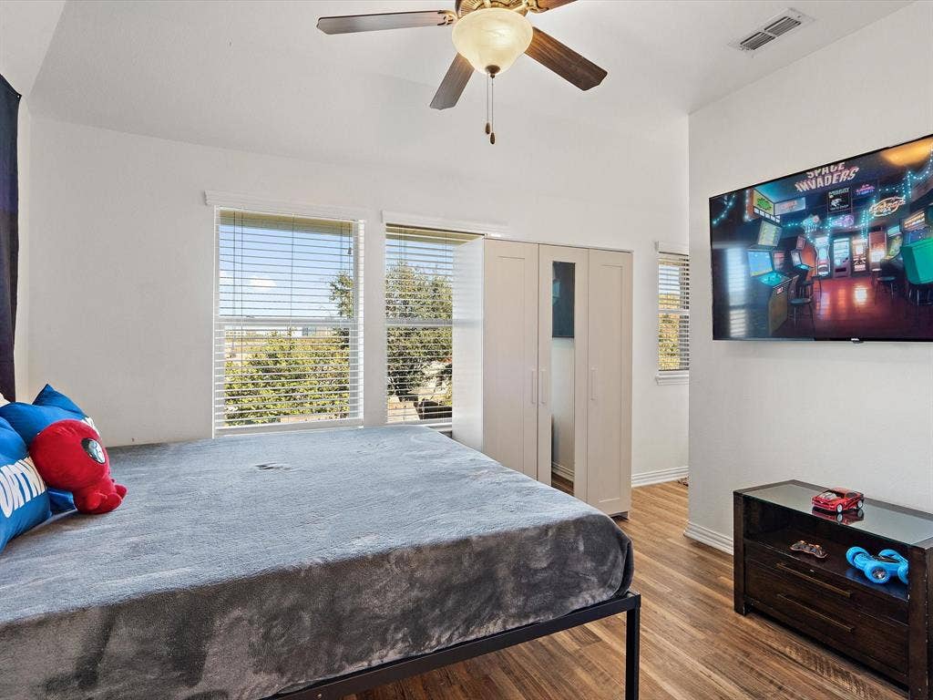 1506 Hennessey Drive, Allen, TX 75013 Bedroom featuring wood finished floors, ceiling fan, and a closet