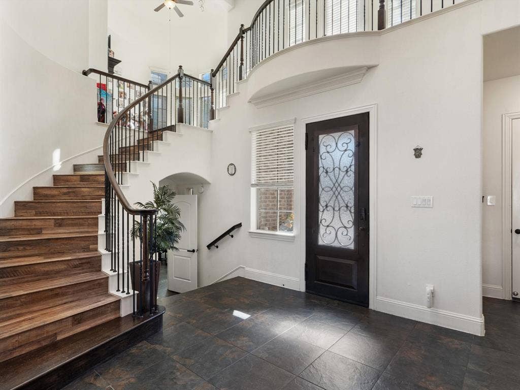 1506 Hennessey Drive, Allen, TX 75013 The entrance boasts an impressive high ceiling, a dazzling chandelier, and exquisite stone tile flooring that sets the tone for elegance.