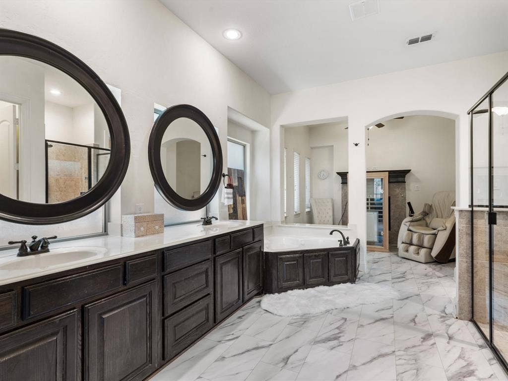 1506 Hennessey Drive, Allen, TX 75013 Full bathroom with a shower stall, light marble finish flooring, double vanity, and a bath