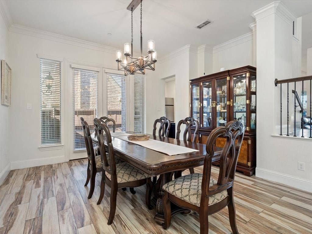 1506 Hennessey Drive, Allen, TX 75013 Dining room with light wood-type flooring, crown molding, and a chandelier