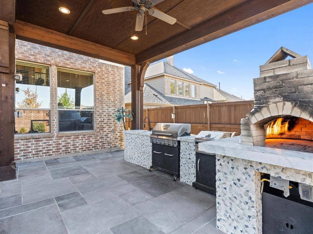 1506 Hennessey Drive, Allen, TX 75013 The covered patio/terrace is a true showstopper, featuring a one-of-a-kind outdoor kitchen with a professional brick pizza oven that's sure to elevate your outdoor dining experience.