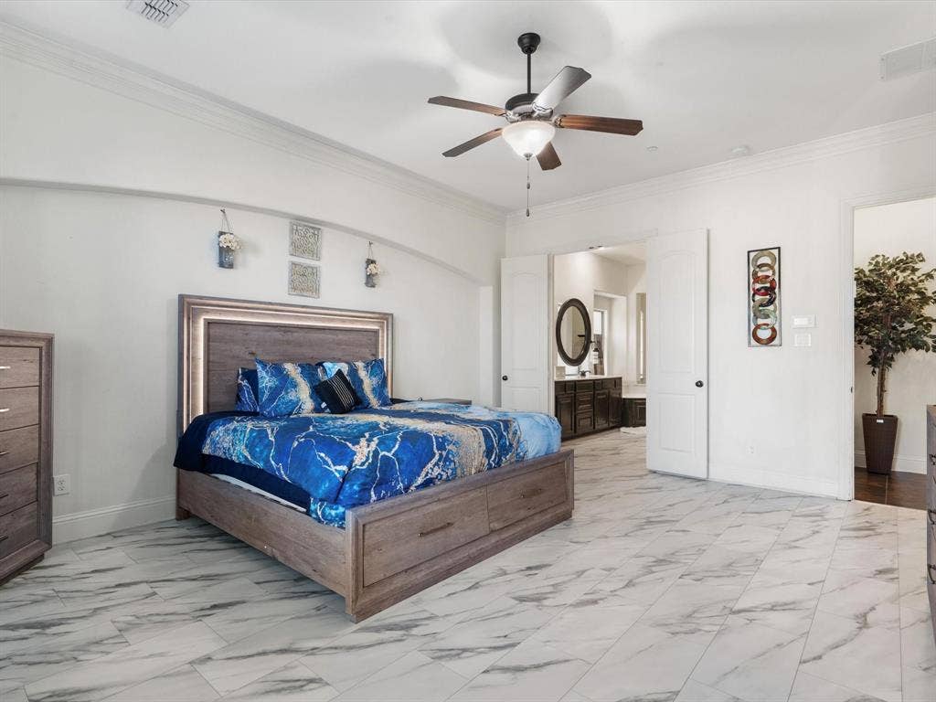 1506 Hennessey Drive, Allen, TX 75013 Bedroom featuring ornamental molding, light marble finish flooring, a ceiling fan, and ensuite bath