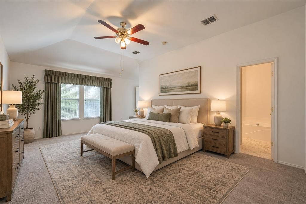 6833 Bluff View Drive, Watauga, TX 76137 Vaulted ceiling, multi-blade ceiling fan with integrated lighting, dual windows with decorative cornice, and carpeted flooring