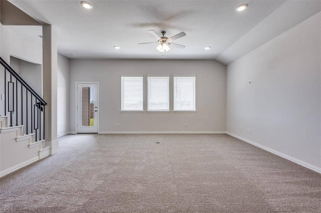 3325 Cross Shore Drive, Anna, TX 75409 Unfurnished living room with stairs, carpet flooring, recessed lighting, and ceiling fan
