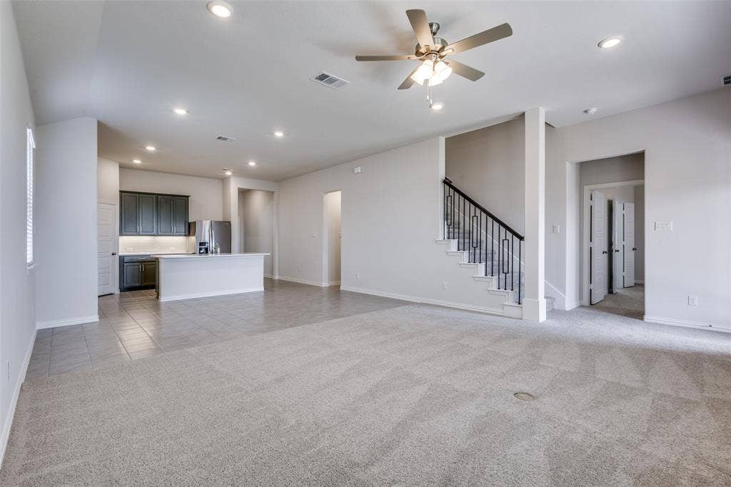 3325 Cross Shore Drive, Anna, TX 75409 Unfurnished living room with a ceiling fan, visible vents, baseboards, light colored carpet, and recessed lighting