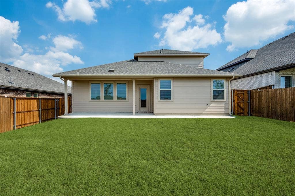 3325 Cross Shore Drive, Anna, TX 75409 Back of house featuring a yard, a patio, a shingled roof, and a fenced backyard