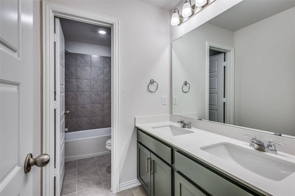 3325 Cross Shore Drive, Anna, TX 75409 Full bath featuring toilet, tile patterned flooring, double vanity, and a sink