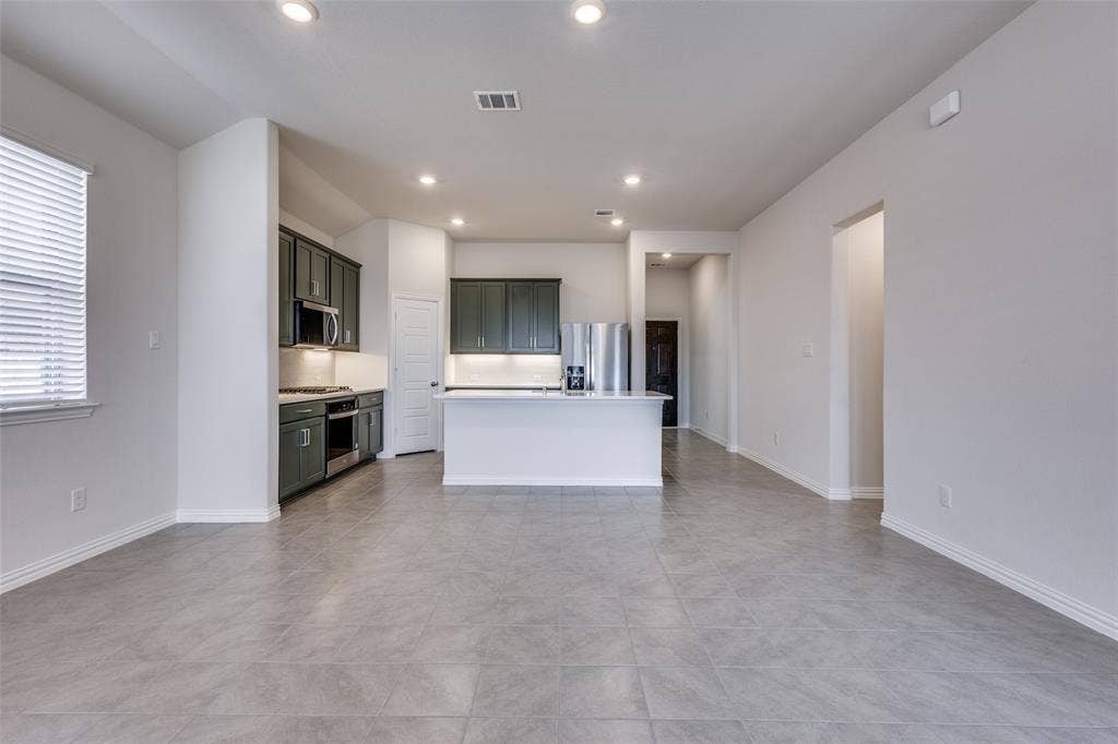 3325 Cross Shore Drive, Anna, TX 75409 Unfurnished living room with light tile patterned flooring, baseboards, visible vents, and recessed lighting