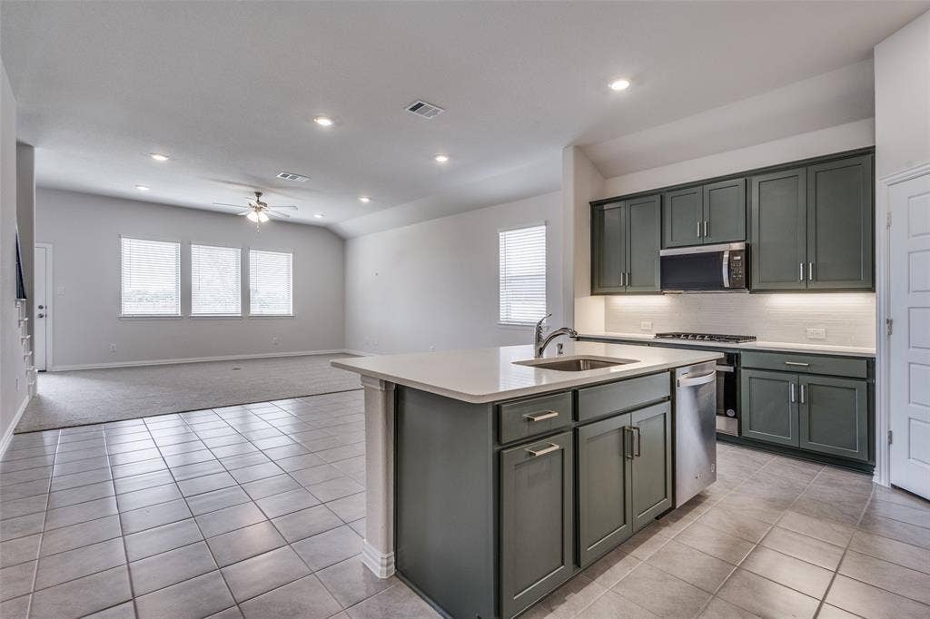 3325 Cross Shore Drive, Anna, TX 75409 Kitchen with stainless steel appliances, ceiling fan, visible vents, a sink, and light countertops