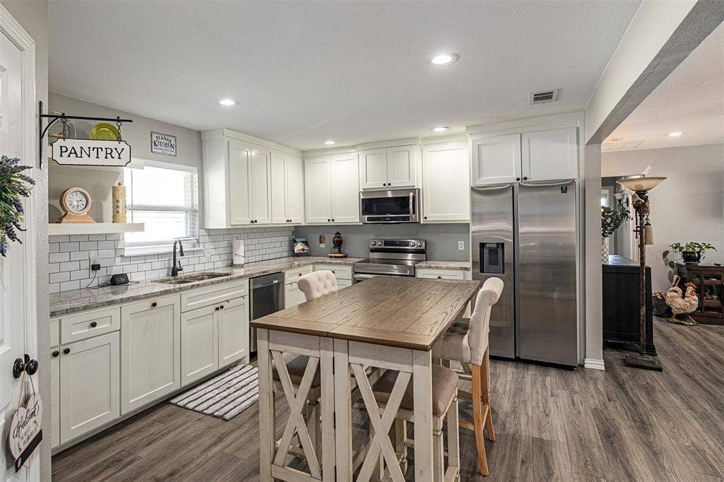519 MAE Drive, Mabank, TX 75147 Kitchen featuring white cabinetry, stone-finish countertops, subway tile backsplash, recessed lighting, and wood-finish flooring