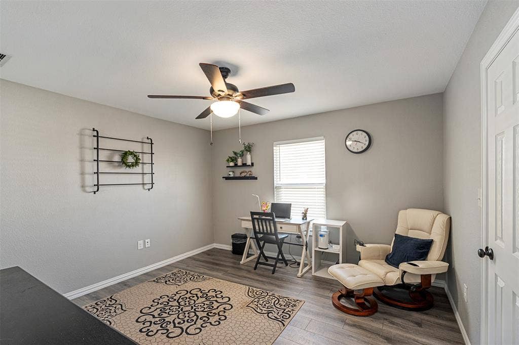 519 MAE Drive, Mabank, TX 75147 Neutral wall color, wood-finish flooring, and ceiling fan with integrated lighting