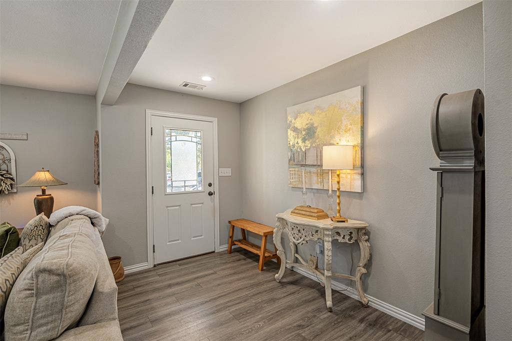 519 MAE Drive, Mabank, TX 75147 Entryway featuring wood-finish flooring, neutral wall paint, and an exterior door with decorative glass paneling