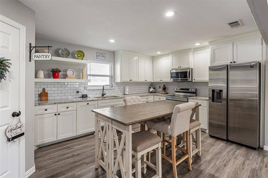 519 MAE Drive, Mabank, TX 75147 Kitchen featuring white shaker-style cabinetry, stone-finish countertops, subway tile backsplash, recessed lighting, and wood-finish flooring