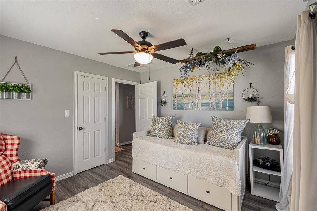 519 MAE Drive, Mabank, TX 75147 Room featuring wood-finish flooring, a multi-blade ceiling fan with integrated lighting, and two six-panel interior doors