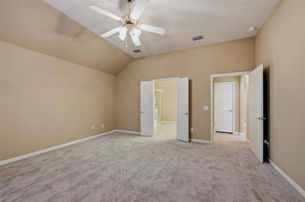 819 Mustang Drive, Fairview, TX 75069 Vaulted ceilings featuring a central overhead fan, neutral wall finishes, plush wall-to-wall carpeting, and double-door entryways