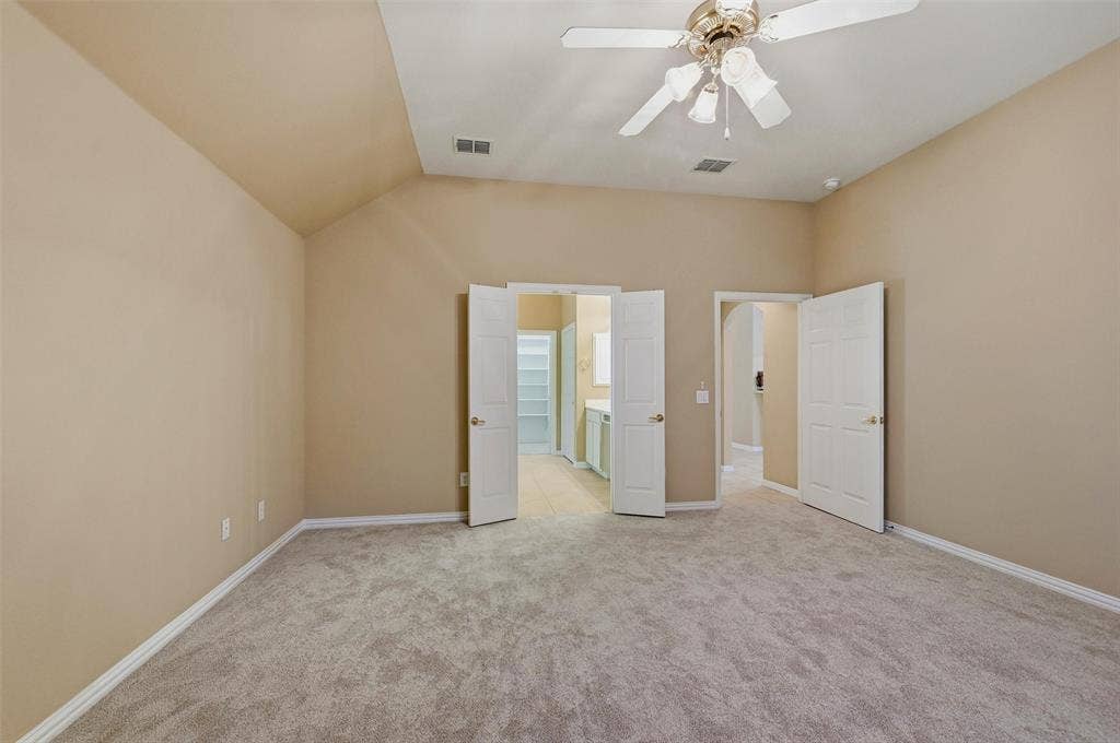 819 Mustang Drive, Fairview, TX 75069 Vaulted ceiling room featuring neutral carpeting, a multi-light ceiling fan, and double-panel entry doors