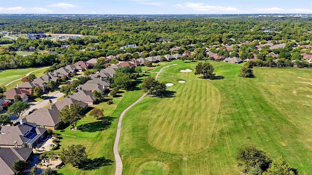 819 Mustang Drive, Fairview, TX 75069 Aerial perspective of a residential community featuring expansive manicured greens, sand bunkers, mature landscaping, and concrete pathways