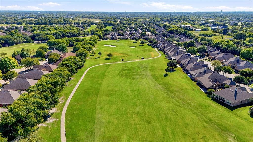 819 Mustang Drive, Fairview, TX 75069 Aerial perspective featuring expansive greenbelt space, paved pedestrian pathway, mature tree canopy, and residential landscape