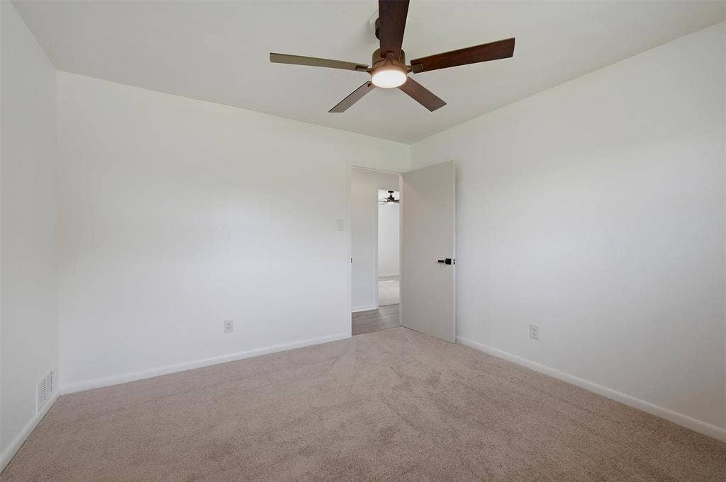 607 N Louisiana Drive, Celina, TX 75009 Neutral-toned carpeting, matte white walls, and a ceiling fan with integrated lighting