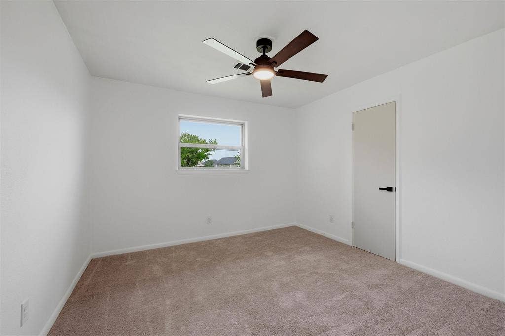 607 N Louisiana Drive, Celina, TX 75009 Neutral-toned carpeting, matte black door hardware, and a ceiling fan with integrated lighting