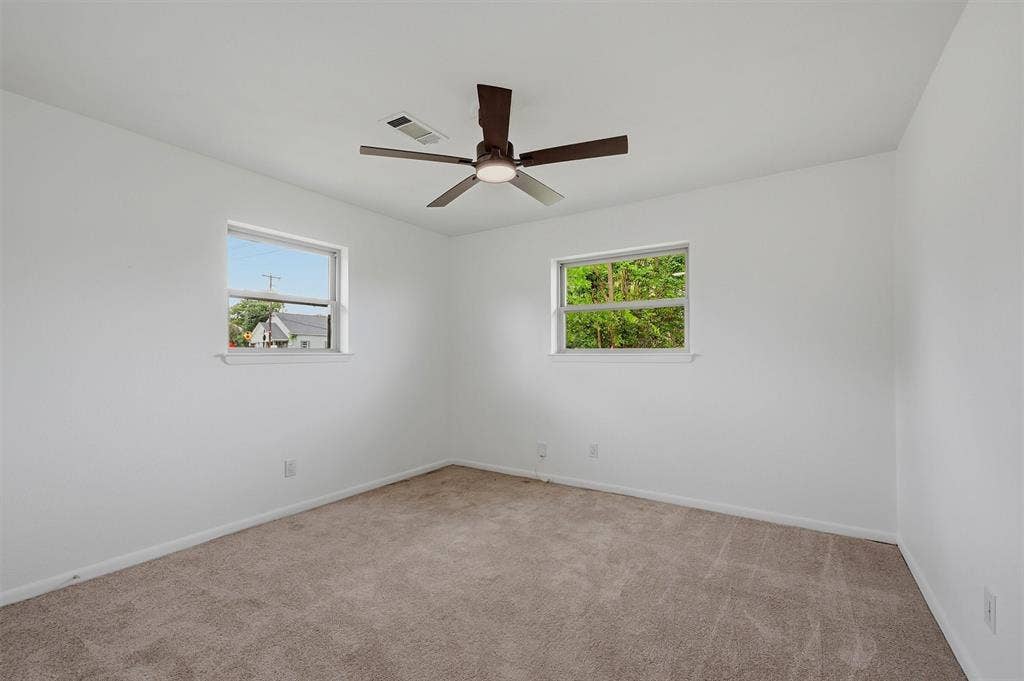 607 N Louisiana Drive, Celina, TX 75009 Neutral-toned carpeting, dual windows, and a central ceiling fan with integrated lighting