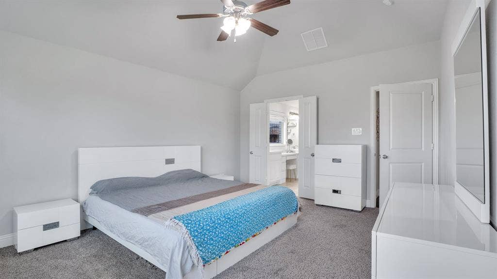 124 Village Creek Drive, McKinney, TX 75071 Vaulted ceilings, neutral wall color, carpeted flooring, and a multi-blade ceiling fan with integrated light fixture