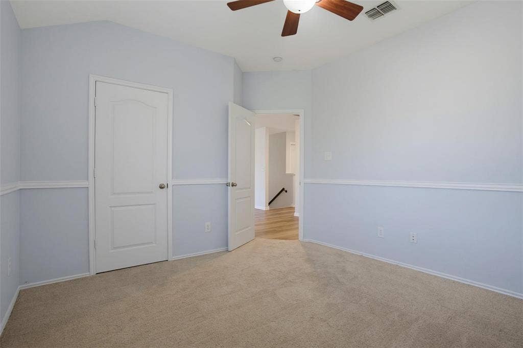 1402 Bradford Trace Drive, Allen, TX 75002 Vaulted ceilings, neutral carpeting, chair rail molding, solid-core interior doors, and a ceiling fan with integrated lighting
