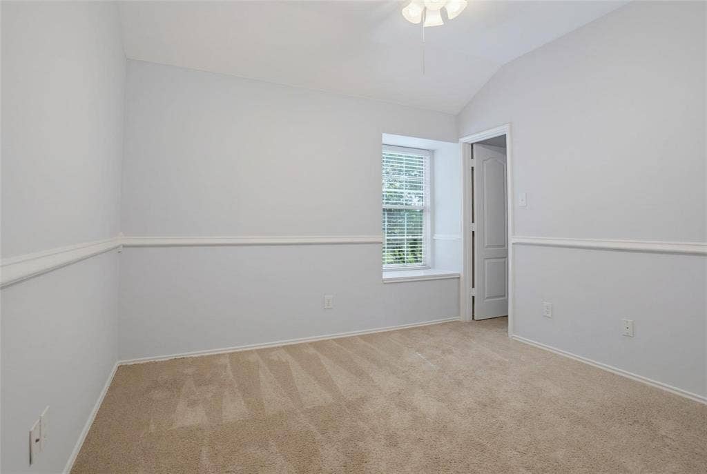 1402 Bradford Trace Drive, Allen, TX 75002 Vaulted ceiling with an integrated light fixture, neutral wall-to-wall carpeting, white chair rail molding, and a built-in window seat