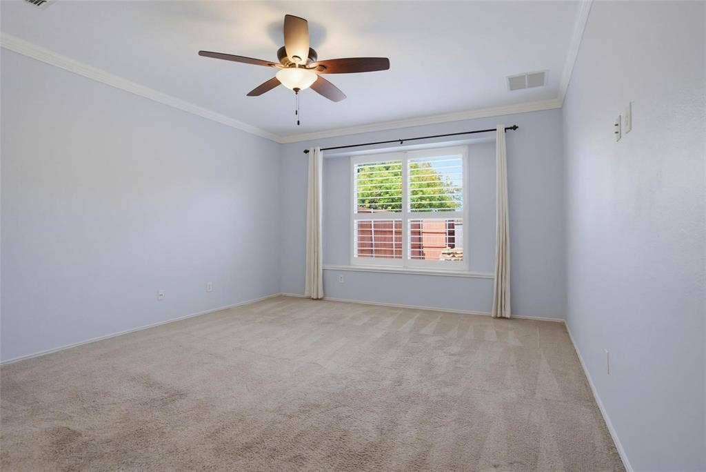 1402 Bradford Trace Drive, Allen, TX 75002 Neutral wall tones, carpeted flooring, multi-pane window with plantation shutters, crown molding, and a multi-blade ceiling fan with integrated light fixture