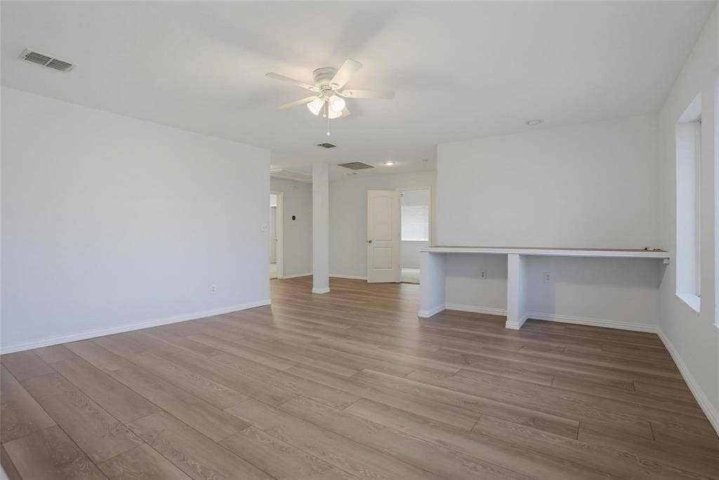 1402 Bradford Trace Drive, Allen, TX 75002 Open-concept room featuring wood-finish flooring, a white ceiling fan with integrated lighting, recessed lighting, and a built-in counter surface