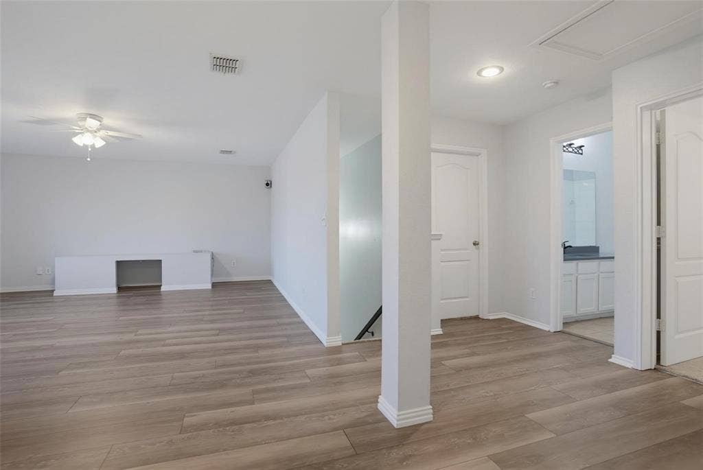 1402 Bradford Trace Drive, Allen, TX 75002 Open-concept area featuring wood-finish flooring, a built-in workstation, recessed ceiling lighting, a flush-mount ceiling fan, and multi-panel interior doors