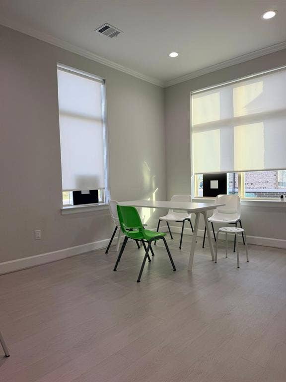 2120 Prairie Drive, #601, Prosper, TX 75078 Neutral-toned interior space featuring wood-finish flooring, recessed lighting, and large windows with integrated roller shades