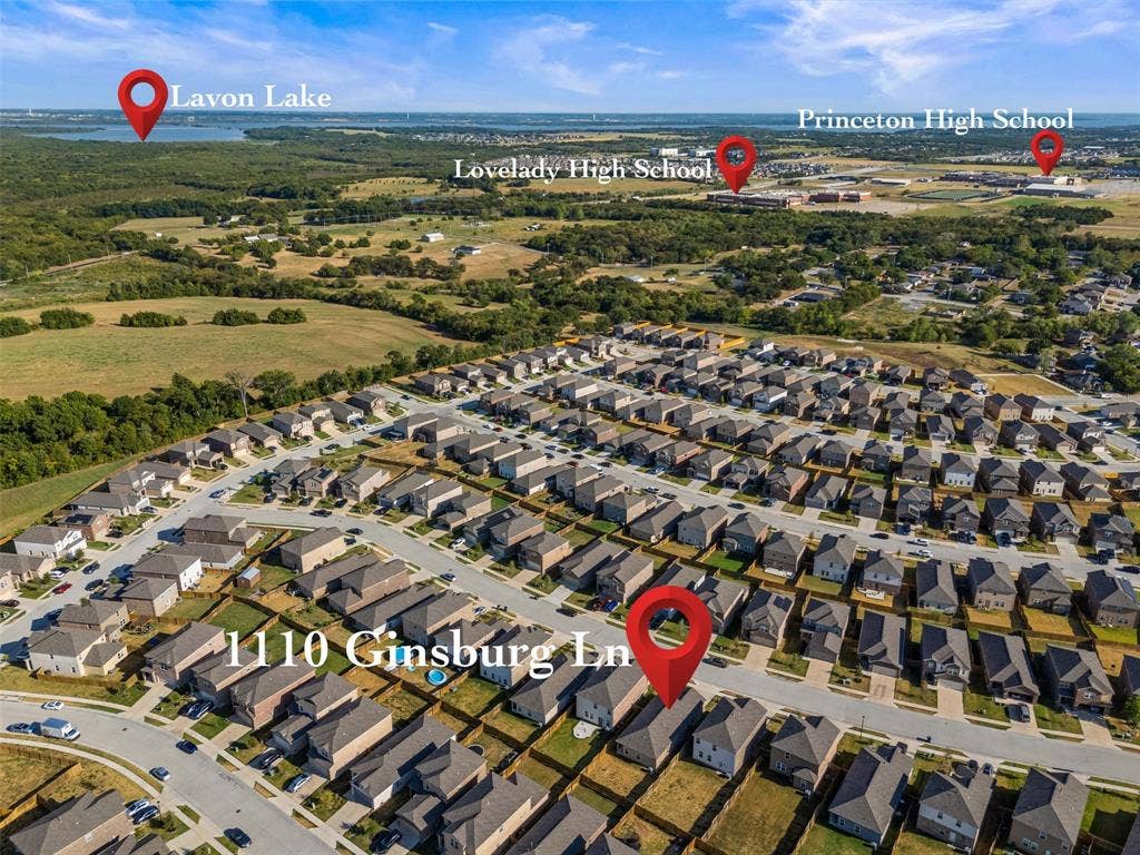 Aerial perspective of a residential development featuring single-family dwellings, paved thoroughfares, and proximity to open acreage