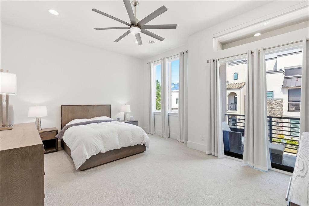 7853 Element Avenue, Plano, TX 75024 High-ceiling bedroom featuring recessed lighting, a multi-blade ceiling fan, expansive windows, and a sliding glass door providing external balcony access