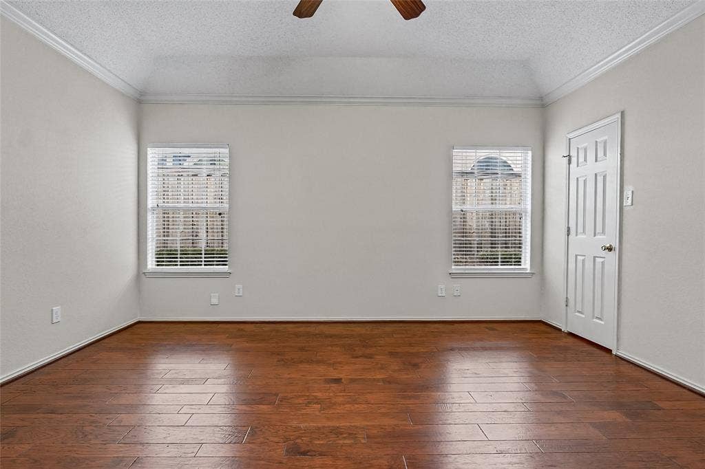714 Cottonwood Bend Drive, Allen, TX 75002 Tray ceiling, wood-finish flooring, two dual-pane windows with horizontal blinds, and a six-panel door