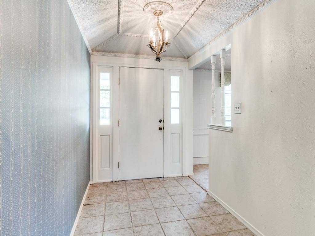 2007 Mistletoe Drive, Richardson, TX 75081 Foyer with vaulted ceiling, a chandelier, and baseboards