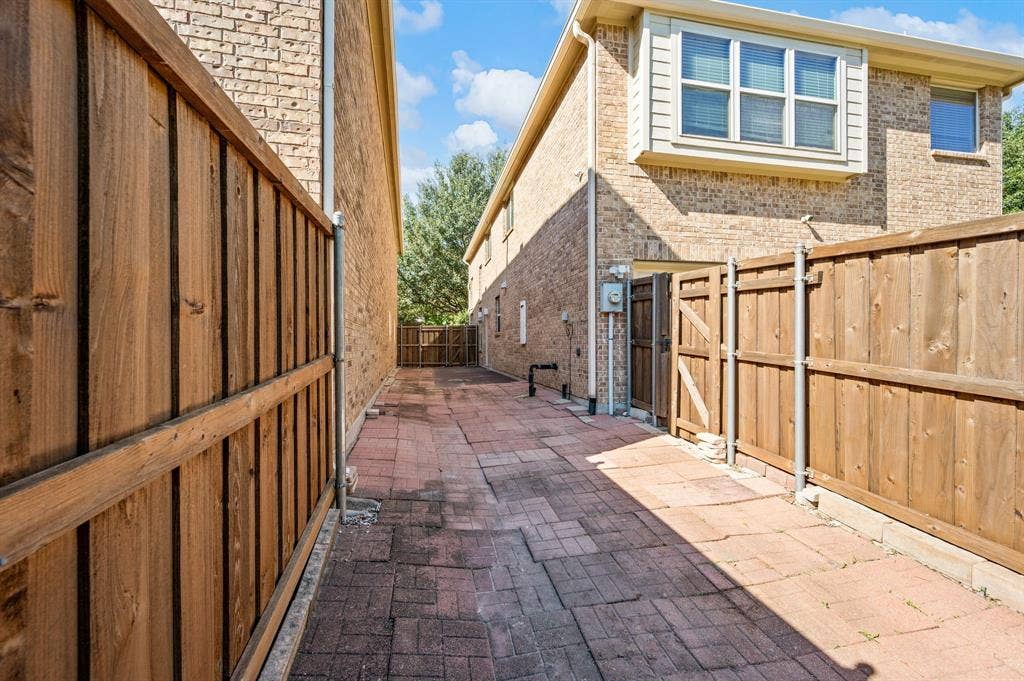 1712 Coronado Street, Allen, TX 75013 Brick exterior siding, paver patio, and wood privacy fencing
