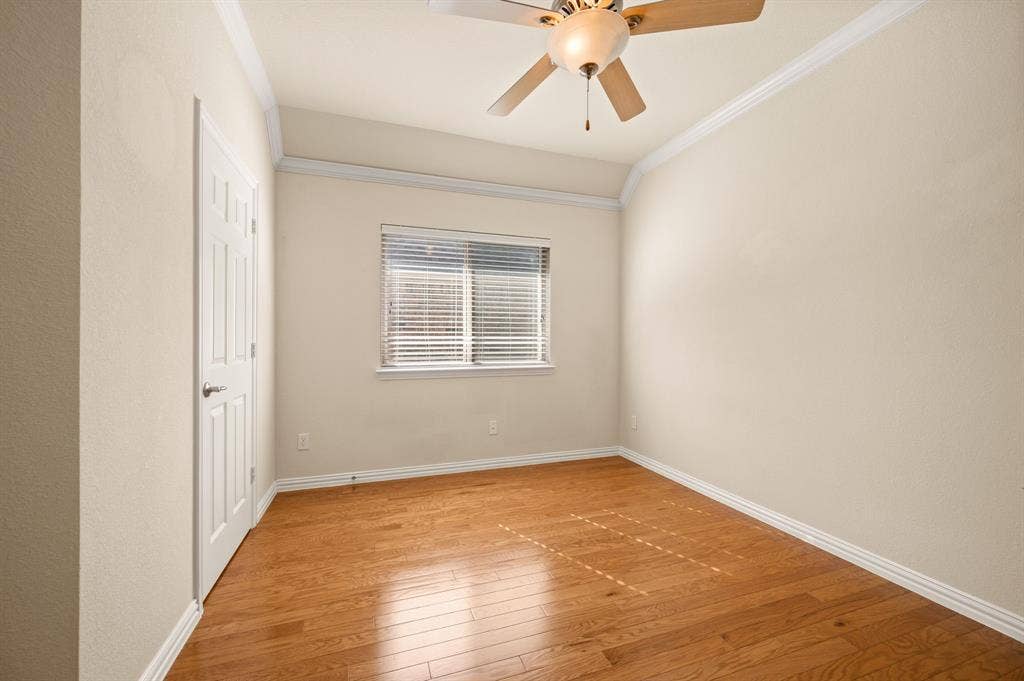 1712 Coronado Street, Allen, TX 75013 Room featuring wood-finish flooring, vaulted ceilings with crown molding, and a central ceiling fan with an integrated light fixture