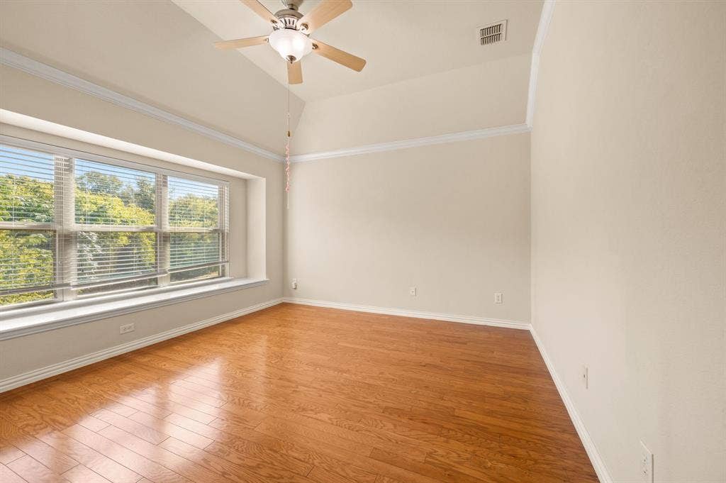 1712 Coronado Street, Allen, TX 75013 Vaulted ceilings with crown molding, wood-finish flooring, and a large bay window featuring an integrated window seat and ceiling fan