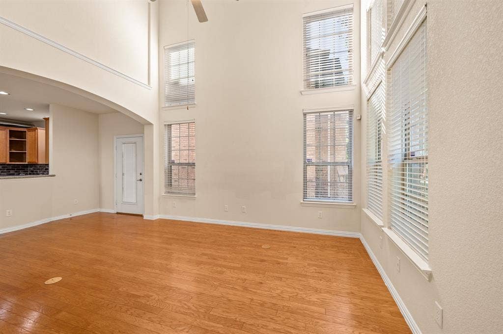 1712 Coronado Street, Allen, TX 75013 High-ceiling room featuring wood-finish flooring, multi-level windows, and crown molding