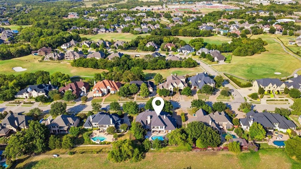 1919 Kings Pass, Heath, TX 75032 Expansive residential neighborhood with mature trees, green spaces, and multiple properties featuring private swimming pools
