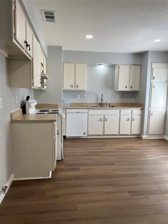 102 Silver Creek Drive, Duncanville, TX 75137 Kitchen featuring cabinetry with matte hardware, solid-surface countertops, wood-finish flooring, and recessed lighting