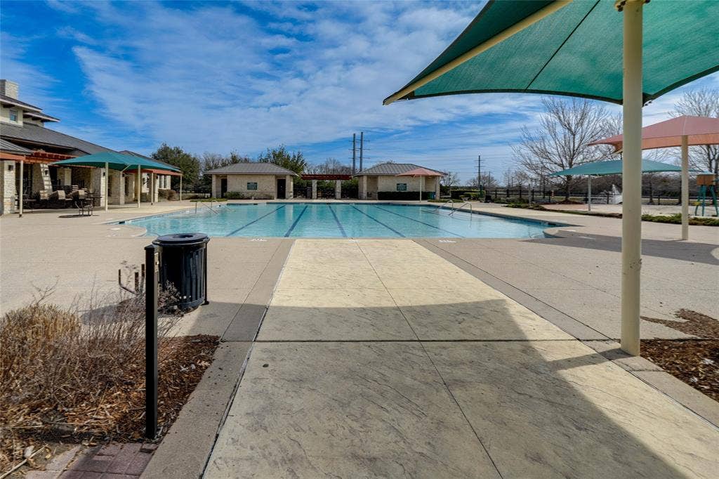 Community pool featuring a patio