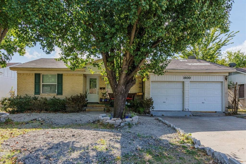 1600 Summit Street, Mesquite, TX 75149 Single-story residence featuring a brick facade, attached two-car garage, and shutter-accented windows